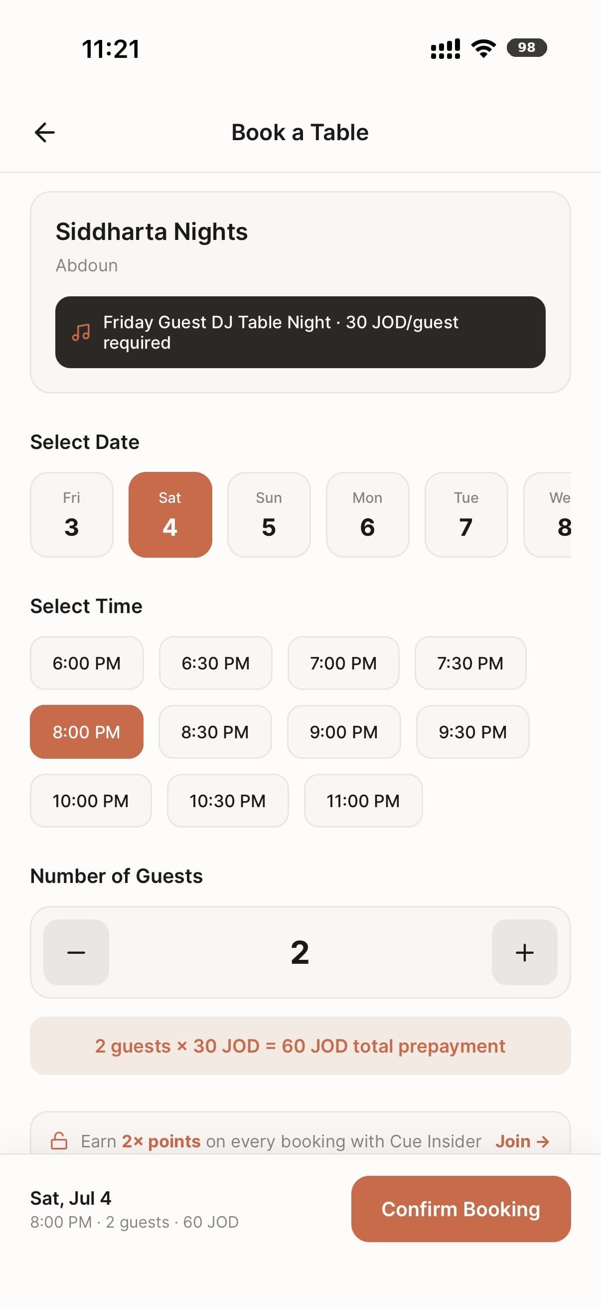 Requesting a table at an Amman restaurant in the Cue app