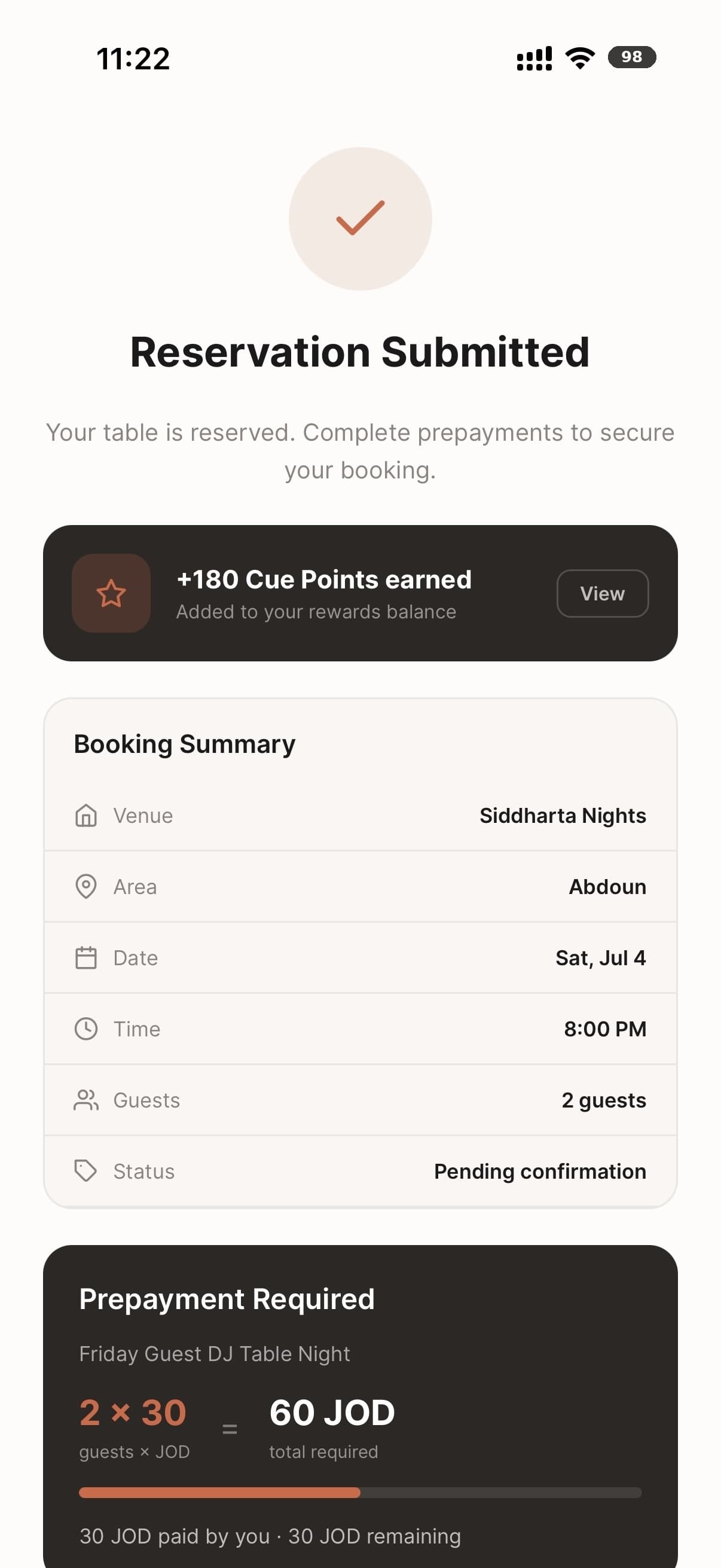 A confirmed restaurant reservation in the Cue app, Amman